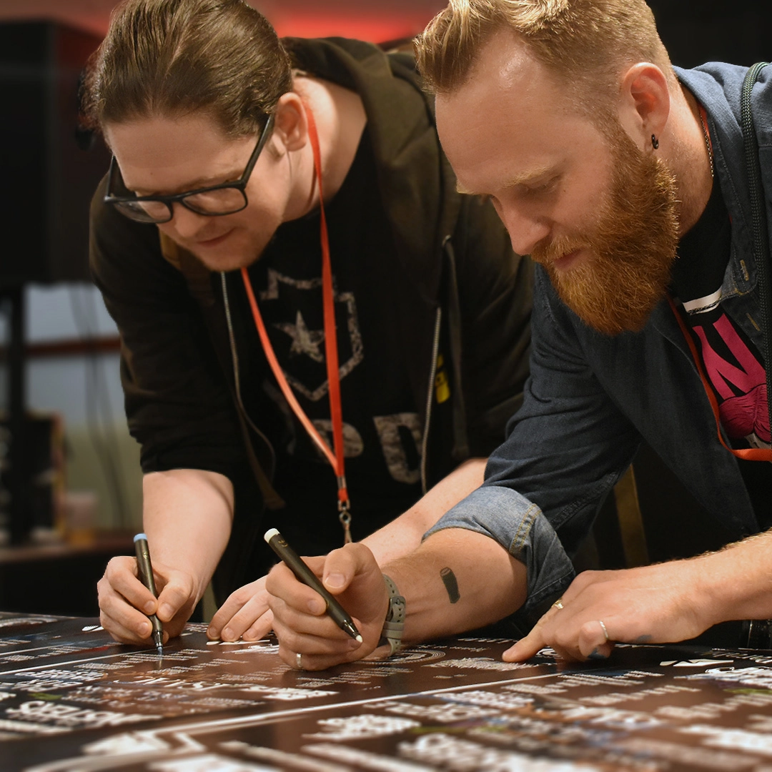 Signing the festival poster